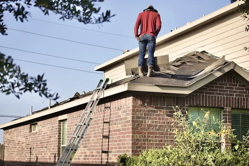 Professional roofer working on a residential roof in Ventura